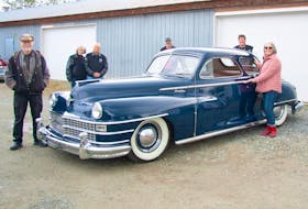 Saanich Peninsula Hospital Foundation executive director Karen Morgan with members of the Torque Masters Car Club that restored the 1947 Chrysler coupe to enhance the lives of dementia patients. Ken Coward photo