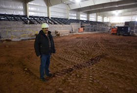Cedric Gallant, project manager for the Tyne Valley Events Centre, stands on the ice surface with the seating area behind him. Gallant, who will also assume the manager's role for the 2021-22 season, said the goal is for the multi-purpose facility to have ice and be open in early October. The events centre will replace the Tyne Valley and Area Community Sports Centre, which was destroyed by fire on Dec. 29, 2019.