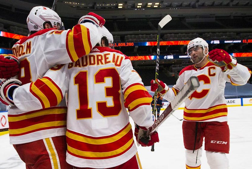 Calgary Flames Johnny Gaudreau (13) celebrates his goal with teammates during second period NHL action against the Edmonton Oilers on Saturday, May 1, 2021 in Edmonton. Greg Southam-Postmedia