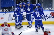 Maple Leafs' Auston Matthews celebrates his 40th goal of the season with teammates during the third period against the Canadiens in Toronto on Thursday, May 6, 2021. 