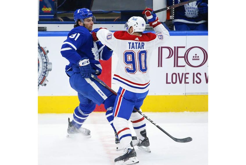 Montreal Canadiens Tomas Tatar LW (90) hits Toronto Maple Leafs John Tavares C (91) during second period action in Toronto on Thursday May 6, 2021. Jack Boland/Toronto Sun/Postmedia Network