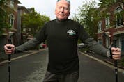 Michael Baine poses for photo in front of his house in Ottawa Wednesday. Michael has stage four prostate cancer that has spread to his bones and hips. Despite that, he's walking 21 kilometres as part of Ottawa Race Weekend to raise money for The Ottawa Hospital Cancer Centre.   