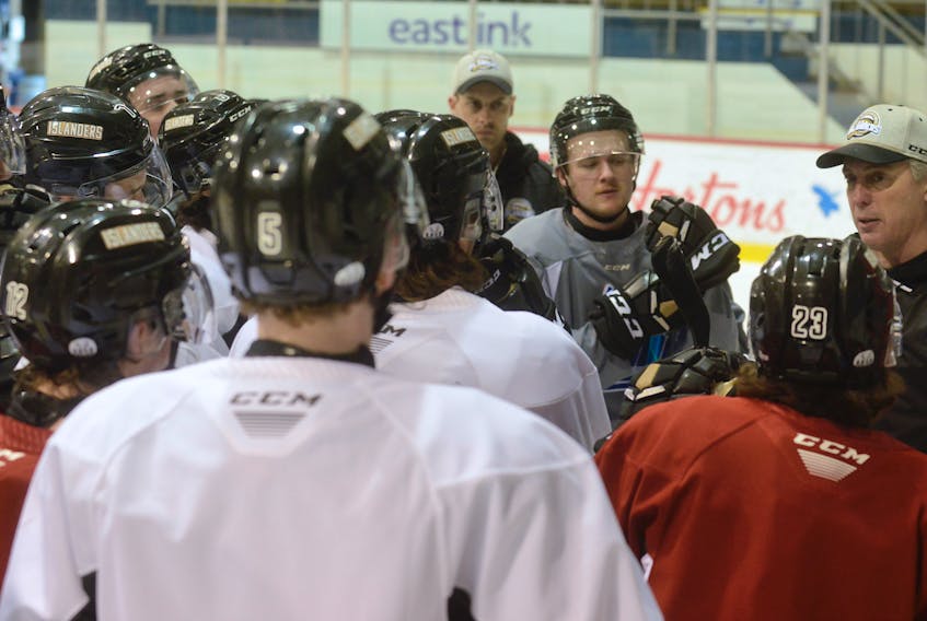 Charlottetown Islanders listen to head coach Jim Hulton, right, at Wednesday’s practice at the Eastlink Centre.