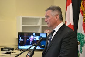 Heath MacDonald speaks to reporters, as Health Minister Ernie Hudson speaks during estimates on the legislature floor. on Friday. MacDonald surprised the minister by tabling an internal memo proving surgeries at PCH will be deferred this weekend.