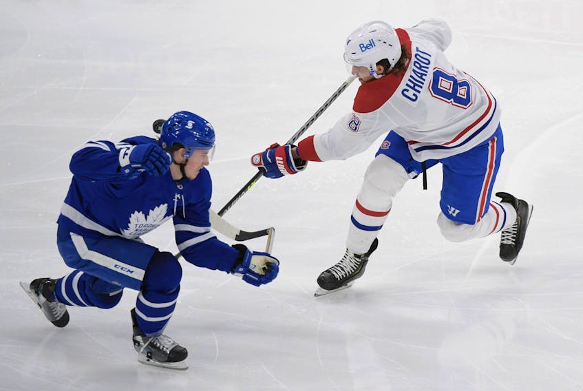 Maple Leafs forward Mitch Marner (left) blocks a shot by Montreal Canadiens defenceman Ben Chiarot on Saturday at Scotiabank Arena. Team defence has helped propel Toronto to the North Division title.