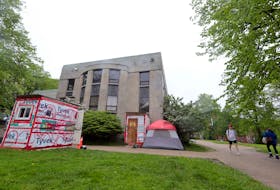 Photo of tents and temporary structures in front of the old Halifax Memorial Library on Spring Garden Road. To go with homelessness housing strategy stories.