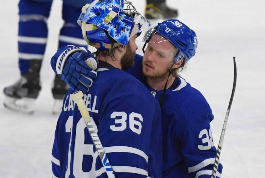 Maple Leafs goalie Jack Campbell is consoled by defenceman Rasmus Sandin after losing to the Canadiens in Game 7 of the first round of the 2021 Stanley Cup Playoffs at Scotiabank Arena in Toronto, Monday, May 31, 2021.
