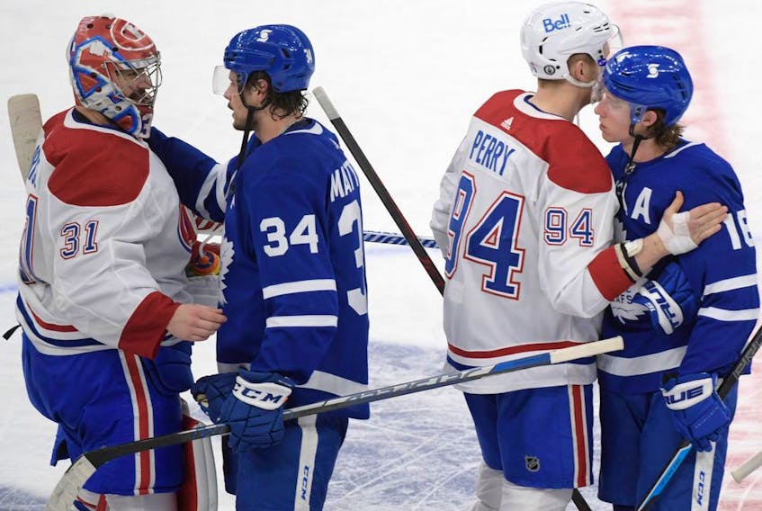 Maple Leafs forwards Auston Matthews (34) and Mitch Marner (16) shake hands with Montreal Canadiens goalie Carey Price (31) and forward Corey Perry (94) after the Canadiens beat the Leafs 3-1 in game seven of the first round of the 2021 Stanley Cup Playoffs at Scotiabank Arena in Toronto on Monday, May 31, 2021.