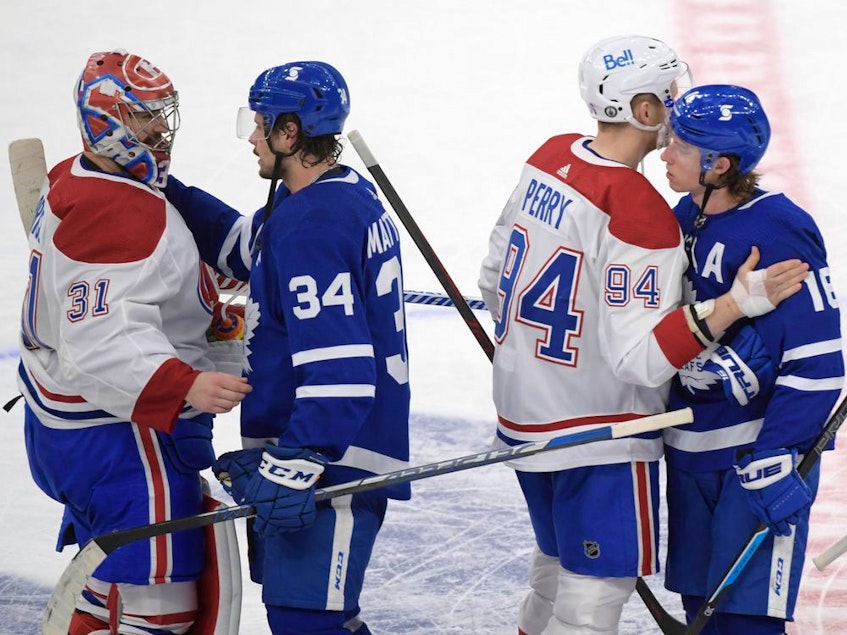 Maple Leafs forwards Auston Matthews (34) and Mitch Marner (16) shake hands with Montreal Canadiens goalie Carey Price (31) and forward Corey Perry (94) after the Canadiens beat the Leafs 3-1 in game seven of the first round of the 2021 Stanley Cup Playoffs at Scotiabank Arena in Toronto on Monday, May 31, 2021. - Dan  Hamilton