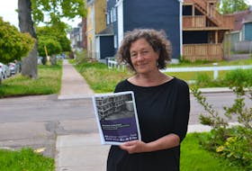 Ann Wheatley of the Cooper Institute holds a copy of the newly published report, Safe at Work, Unsafe at Home. The report shows that temporary foreign workers in P.E.I. face crowded and unsafe housing conditions and documents "unscrupulous" practices by local employers. 