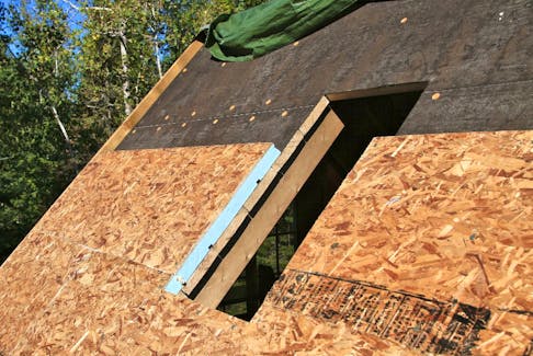 This roof is being insulated from the top using rigid sheets of extruded polystyrene foam. It allows the roof boards and rafters to remain visible from inside when maximum insulation levels are not needed. 