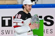  Canada’s forward Andrew Mangiapane poses with the trophy for best player during the ceremony after the IIHF Men’s Ice Hockey World Championships final match between the Finland and Canada at the Arena Riga in Riga, Latvia, on June 5, 2021. – A 3-2 victory over Finland crowned Canada Ice Hockey World Champions 2021.