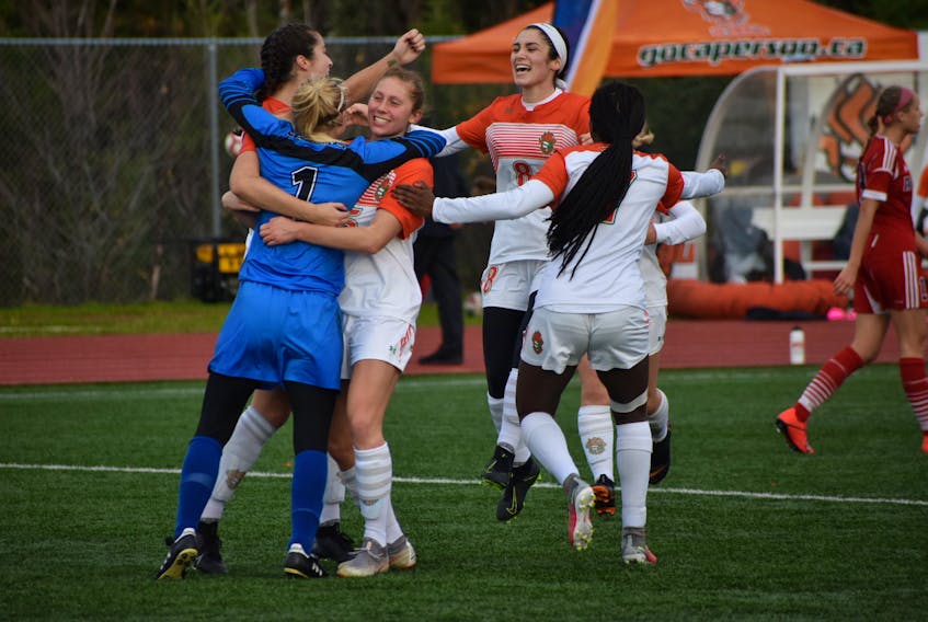 In this 2019 file photo, members of the Cape Breton Capers women's soccer team celebrate after capturing their third consecutive Atlantic University Sport championship with a 3-2 victory over the Acadia Axewomen at the Cape Breton Health Recreation Complex Turf. The AUS plans to return to full competition in September following the 2020-21 season cancellation due to the COVID-19 pandemic. JEREMY FRASER • CAPE BRETON POST
