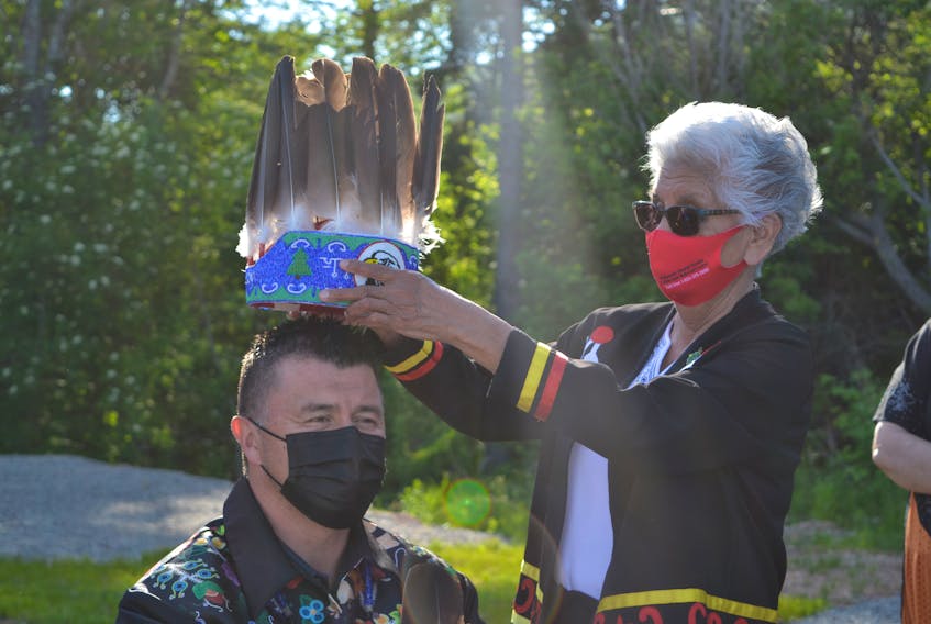 Eskasoni Chief Leroy Denny receives the traditional chief's headdress for his fifth term by community elder and residential school survivor Georgina Doucette during the inauguration ceremony on Wednesday evening. ARDELLE REYNOLDS • CAPE BRETON POST 