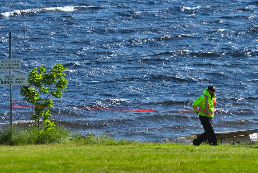 FOR NEWS STORY:
A parks employee puts up caution tape across the beach at Oakfield Park in Grand Lake....the lake is now closed to all boating, fishing, swimming etc....for CAMPBELL STORY.
