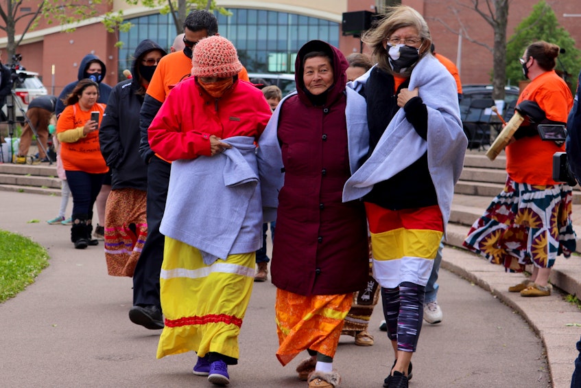 Three residential school survivors lead a walk and smudging ceremony at Confederation Landing in honour of those harmed by the residential school system. - Logan MacLean