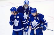 Maple Leafs’ Auston Matthews (34), Mitchell Marner (16) and Jack Campbell skate off in dejection after being eliminated by the Montreal Canadiens, in Toronto on  Monday, May 31, 2021. (Nathan Denette, The Canadian Press)