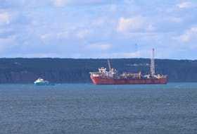 The Terra Nova floating production, storage and offloading (FPSO) vessel in Conception Bay with a supply ship. Telegram file photo