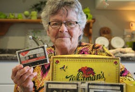 Marie Sonier holds a tape containing her father playing songs on the harmonica. The tape was one she got for Christmas six months after his death in 1981, but never listened to before it was lost.