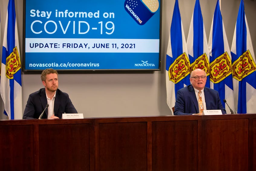 Nova Scotia Premier Iain Rankin and Dr. Robert Strang, chief medical officer of health, speak at a news briefing on June 11, 2021, in Halifax.