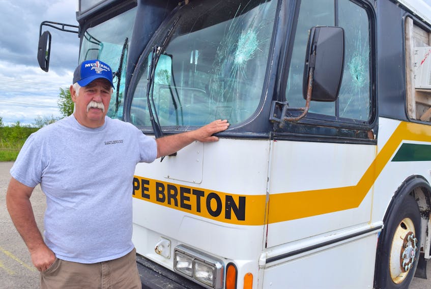 Gary Pozzebon, president of the Cape Breton Drag Racing Association, shows some of the damage to their bus at their race track off Grand Lake Road in Sydney. Pozzebon said they’ve occurred several incidents of vandalism and theft during the five years they’ve been there and are now having discussions about the land-use agreement they have with local ATV groups. Sharon Montgomery-Dupe/Cape Breton Post