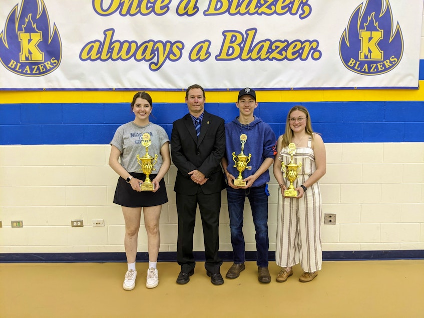 Faith Reeves, left, and Abigail Rogers, right, were named co-recipients of the female school spirit award at Kinkora Regional High School. Colton Lowther, second right, received the male award. Athletic director Trent Ranahan offered congratulations following the awards ceremony for the 2020-21 school year. - Contributed