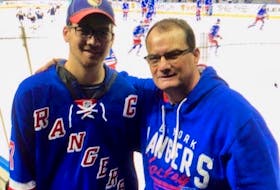 Ron Hennessey, right, and his son, Lal, enjoy a New York Rangers’ game at Madison Square Garden. Ron Hennessey, who has cheered for the Rangers for over 40 years, is excited to have Summerside native Gerard (Turk) Gallant named as head coach of the Original 6 NHL franchise.