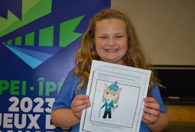 Myla Doucette, a Grade 3 student at Gulf Shore Consolidated School in North Rustico, P.E.I., holds her submission to the 2023 Canada Winter Games mascot design contest. It has been chosen as the winning entry and will be featured on the official mascot as well as on merchandise.
