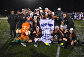In this 2019 file photo, the Cape Breton Capers men’s soccer team is shown with the Atlantic University Sport championship banner and trophy following their 2-0 overtime win over the St. Francis Xavier X-Men in the league final at Cape Breton Health Recreation Complex Turf. The Capers will open the 2021 season in September and will host the AUS championship in November in Sydney. JEREMY FRASER • CAPE BRETON POST