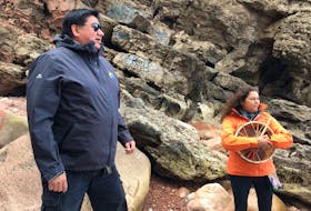 Clifford Paul, a guide who has made close to 200 trips to Kluskap's Cave, tells the legend of Kluskap and the Stone Maidens as he and Tara Lewis look out over the Atlantic Ocean to the Bird Islands. ARDELLE REYNOLDS/CAPE BRETON POST
