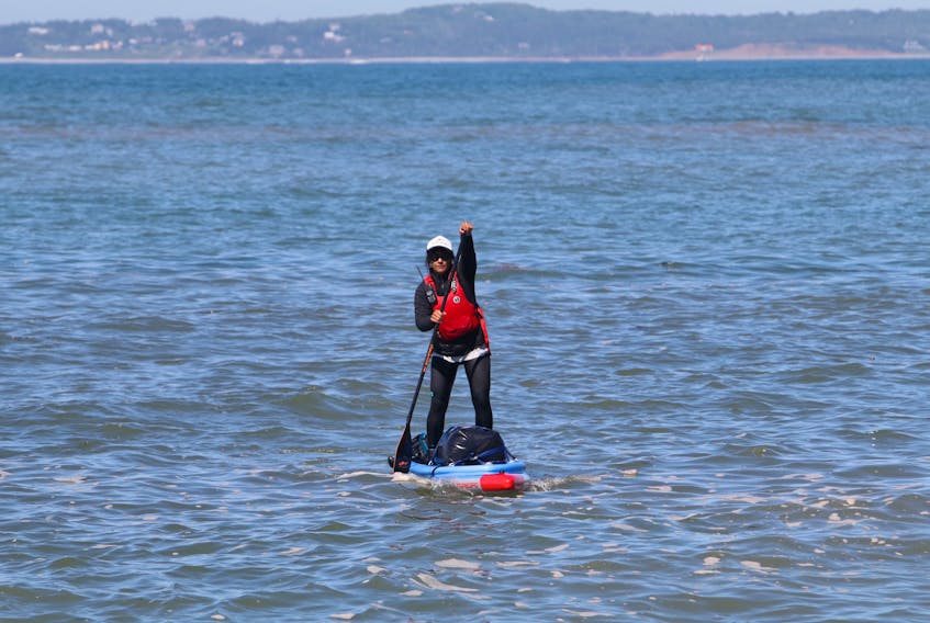 Mariele Guerrero checks the swell on her stand up paddle board for the next leg of their journey after making a stop around Half Island Point, near Lawrencetown Friday. Guerrero is circumnavigating around Nova Scotia, a 1,500-kilometre trip around mainland Nova Scotia on a stand-up paddleboard.