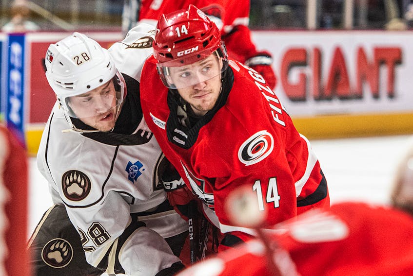 Lingan product Cavan Fitzgerald battles for position during an American Hockey League game with the Charlotte Checkers — affiliate of the Carolina Hurricanes — during the 2019-20 season. Fitzgerald, who played last season with the Chicago Wolves, recently returned to the Hurricanes organization on a two-year, two-way contract. CONTRIBUTED • CHARLOTTE CHECKERS