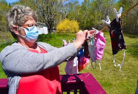 Linda Head of Grand Lake Road in Sydney hangs face masks after washing them by hand with detergent. Health officials say bacteria can live on masks and they must be washed regularly. Sharon Montgomery-Dupe • Cape Breton Post