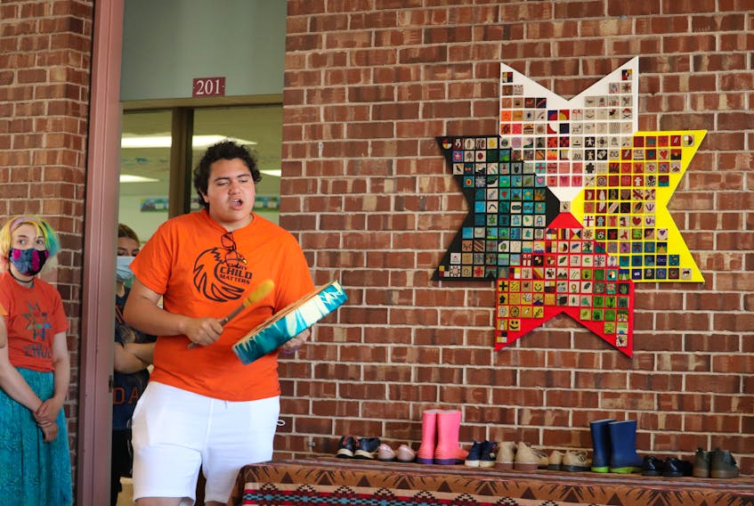 Cora Handrahan, left, and Sean Pellissier-Lush help present the eight-pointed star created by Corinne Chappell's Indigenous studies class at Colonel Gray High School. 