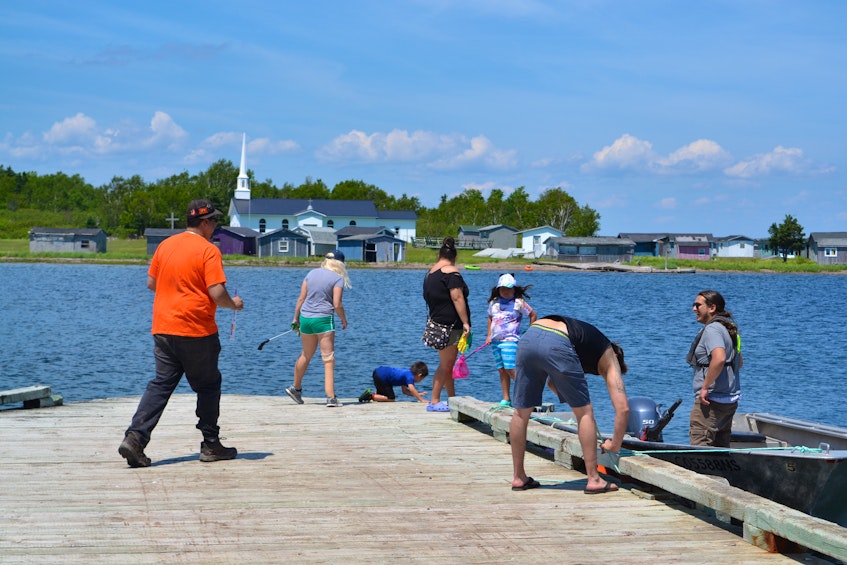 Potlotek Fisheries hosted a community cleanup along the shoreline of the Bras d'Or Lakes for National Indigenous Peoples Day. Chapel Island, the sacred meeting site of the Saint Anne's Mission is pictured in the background. ARDELLE REYNOLDS/CAPE BRETON POST - Ardelle Reynolds