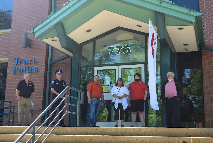 Community representatives gathered to commemorate National Indigenous Peoples Day in front of the Truro Police Station. Left to right: Truro Mayor Bill Mills, Truro Police Chief Dave MacNeil, Millbrook First Nation Chief Bob Gloade, Native Council of Nova Scotia Chief and President Lorraine Augustine, youth Landon Higgins and Maritime Aboriginal Peoples Council Director and elder Roger Hunka. 
