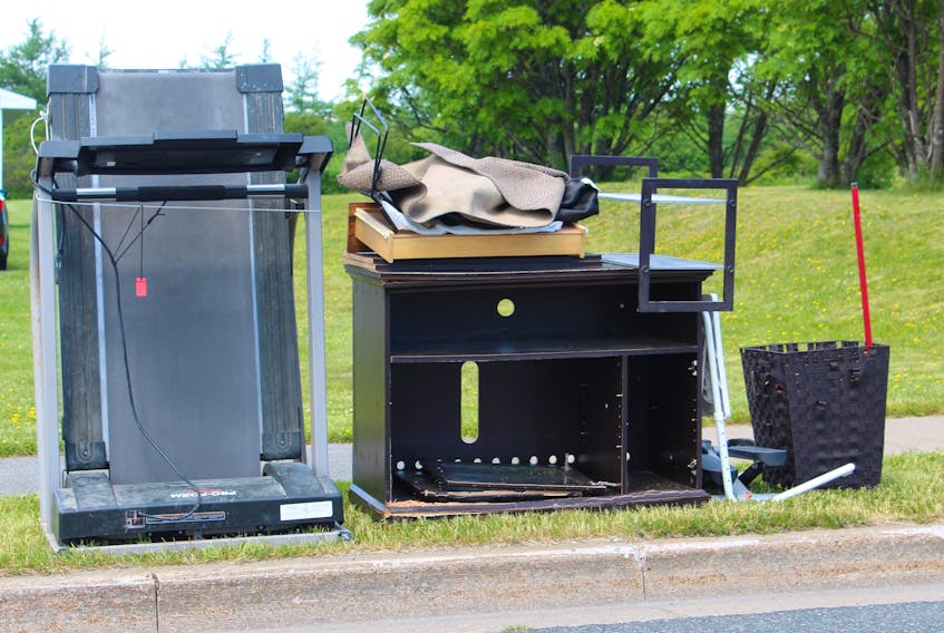 A treadmill is placed on the curbside near a Dominion home on Monday, along with other items deemed heavy garbage. IAN NATHANSON • CAPE BRETON POST