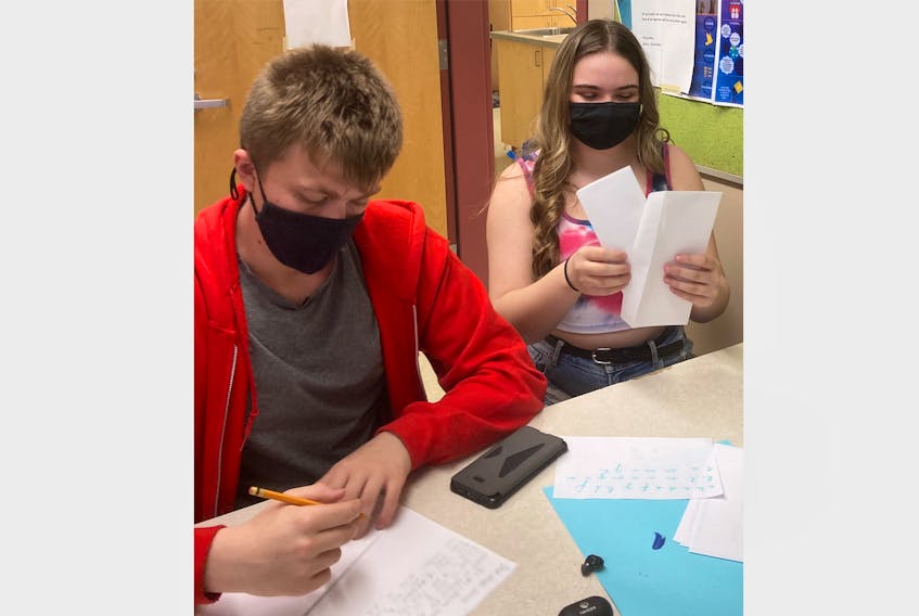 Colby Cunningham and Sarah Penney are among students in the health and human services class at Dr. J.H. Gillis to write letters to residents at the R.K. MacDonald Nursing Home in Antigonish.