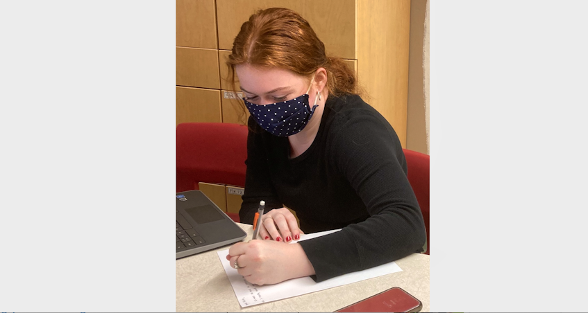 Lauren Decoste writes a letter to a senior at the R.K. MacDonald Nursing Home as part of a pen pal project for Mrs. Synishin’s Grade 12 health and human services class. - CONTRIBUTED