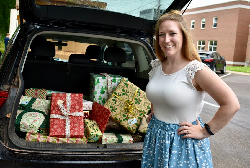 Julia Clayton-Clark stands excitedly by her trunk full of presents for her parents in Nova Scotia. Clayton-Clark will be heading to N.S. to see them on the first ferry crossing on June 23.