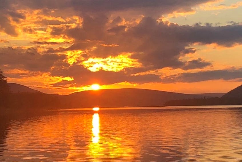 This lovely photo is for all of you with family connections to beautiful Cape Breton Island.  The tangerine sky photo was taken by Lisa Murray, coincidentally enough in Orangedale East on the shores of the Bras D'Or Lakes.  This showstopper of a sunset filled the sky last Sunday - Father's Day!  

Lisa says: "It is my favourite spot as I spent many a day there years ago while my dad was working around his oysters (he passed in 2005).  I had a feeling the sunset wouldn't disappoint, and it didn't!"