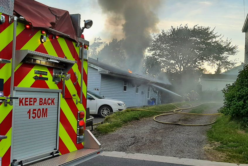 Firefighters battle a structure fire on Herbert Street in Sydney Wednesday evening. The fire is believed to have started around 8:20 p.m. The cause of the fire was unknown at press time.