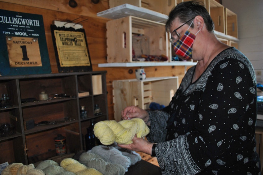 Barrington Woolen Mill heritage interpreter Linda Symonds sets out some naturally dyed wool for retail at the museum this summer. KATHY JOHNSON 