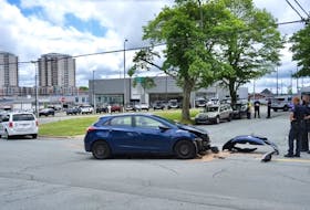 A car sits at the site of a fatal crash at the corner of Stairs and Robie streets in Halifax on Wednesday, June 23, 2021.
