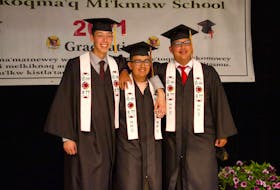 Logan Prosper, right, stands arm and arm with two of his friends at their graduation ceremony at We’koqma’q Mikmaw School on June 16. With him are, from left, Brayden Googoo and Owen Bernard. CONTRIBUTED 