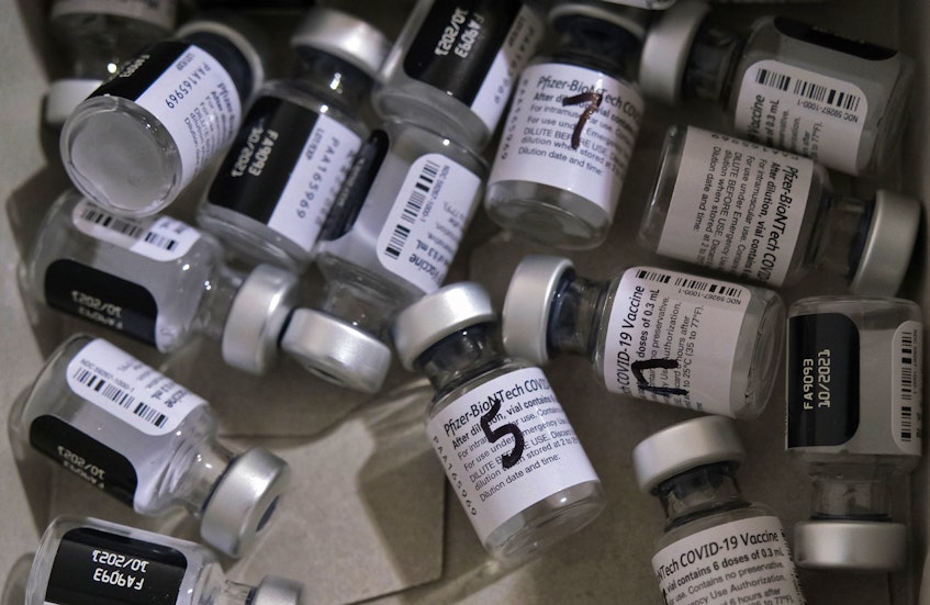 Empty bottles of Pfizer-BioNTech COVID-19 vaccine, after being dispensed in the mass drawing area of a Dartmouth vaccination clinic Wednesday, June 23, 2021. - Tim  Krochak
