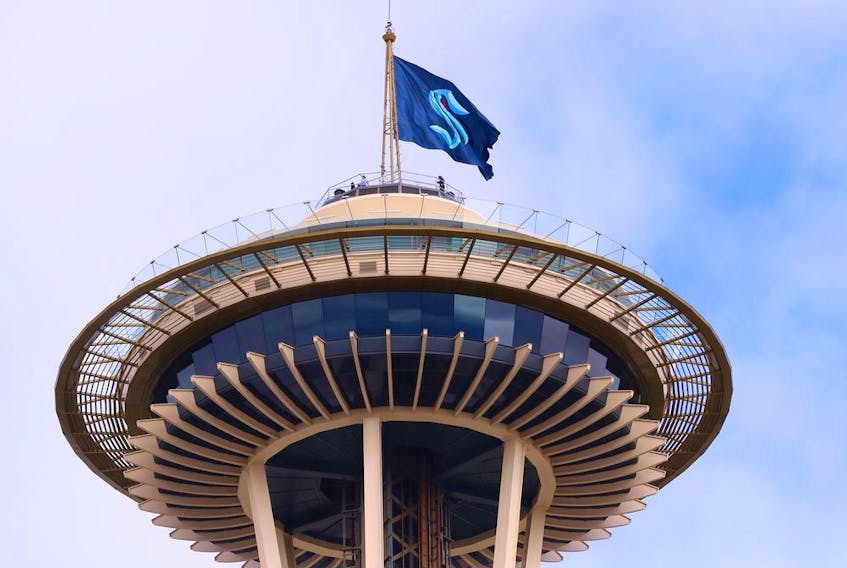 A general view of the Space Needle as the Seattle Kraken team flag is hung from above on July 23, 2020 in Seattle, Washington. 