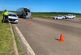 RCMP stand by the Trans-Canada Highway at the Nova Scotia border in Fort Lawrence early Thursday, a day after they broke up a blockade that stopped traffic from entering or leaving the province.