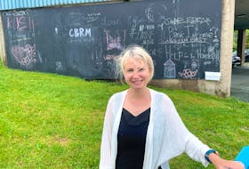 Lisa Mulak, regional librarian at the Cape Breton Regional Library, stands in front of the community chalkboard they installed on a large concrete wall at the Sydney branch. Mulak said it’s a way to give the community an outlet for creative expression at a time when they can’t host in-person programs. Chris Connors/Cape Breton Post