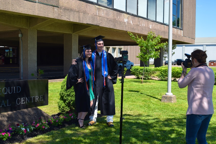 Emma Chisholm and Peter Altenkirk pose for a photo while doing a photography session with their friends. She said she is happy to have closure after suddenly finishing her IB classes at the end of April.  - Chelsey Gould